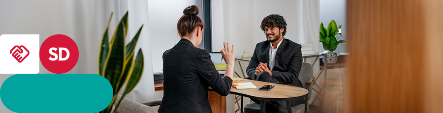 Two people are sitting in a Job interview