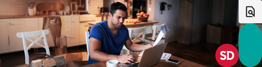 one hand is working on the computer and the other is holding the A+ Certification Study Guide