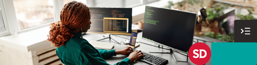 Working on a code, on the computer screen and by that she is Understanding the Cybersecurity Certification Landscape