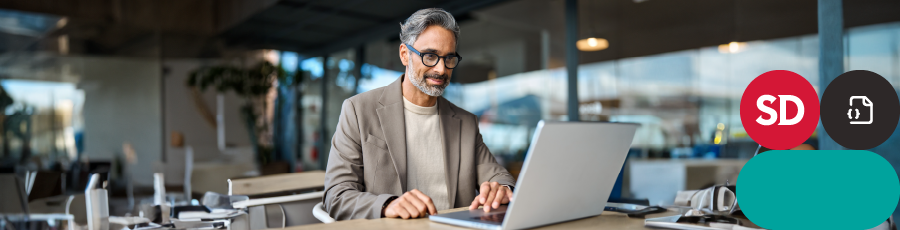 smiling while looking onto a computer screen and Keeping Your Certification Current