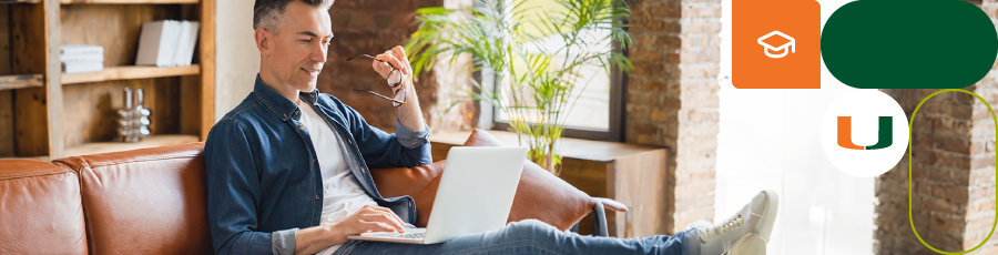 "Person with a laptop on a brown leather couch in a well-lit room with plants, bookshelves, and decor."